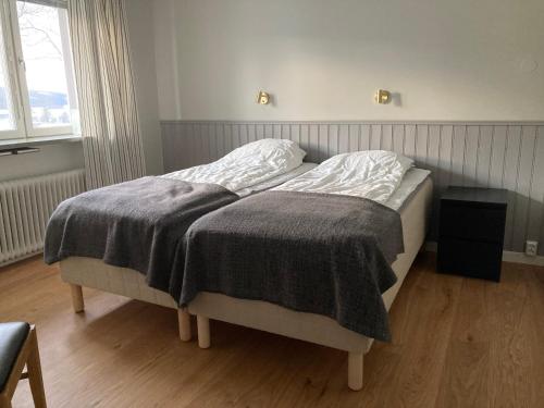 a bed with a blanket on it in a bedroom at Åreguiderna - Bubblans lägenheter Åre Torg in Åre
