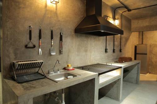 a kitchen with a sink and a stove top oven at Casa en Allende con alberca (Casa Guaname) 