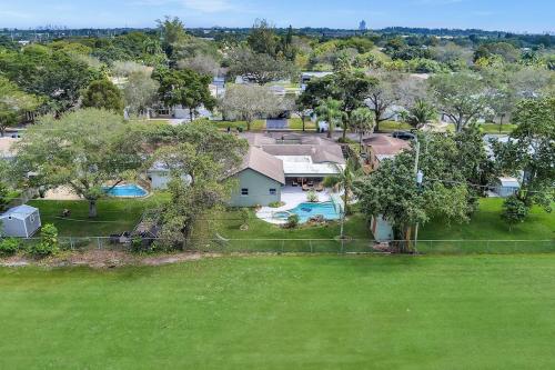 an aerial view of a house with a yard at Pool Heat I Firepit and BBQ I 75"TV I Foosball I 581mbps in Cooper City