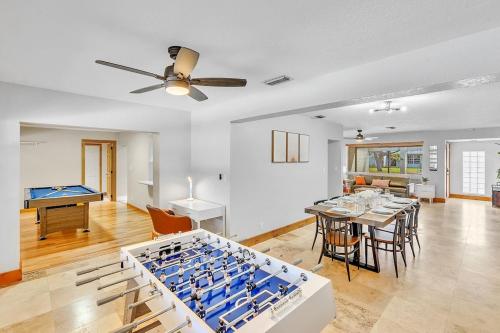 a living room with a ping pong table at Pool Heat I Firepit and BBQ I 75"TV I Foosball I 581mbps in Cooper City