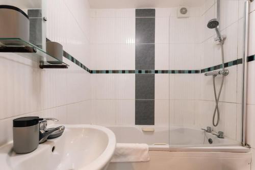 a bathroom with a sink and a shower and a tub at Azurite - 2 bedroom Flat in Southampton