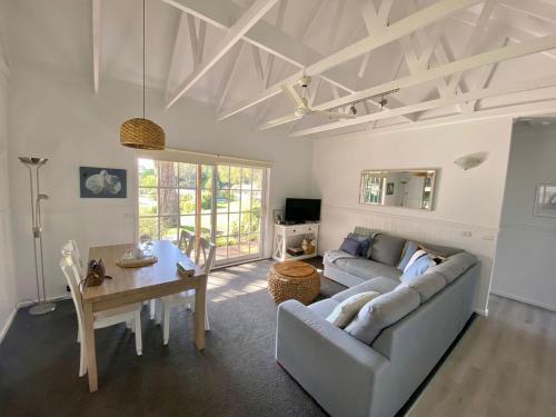 a living room with a couch and a table at McMillans of Metung Coastal Resort in Metung
