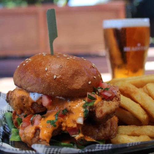 a sandwich and french fries and a glass of beer at Family Hotel in Bathurst