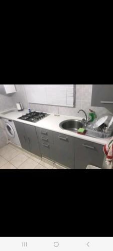 a small kitchen with a sink and a stove at Holiday House maisonette in Limassol