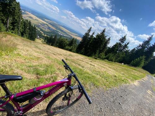 a bike parked on the side of a hill at Enzian by Mountain ways in Loučná pod Klínovcem