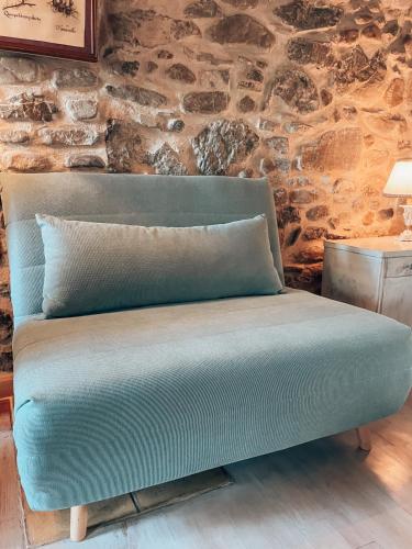 a bench in a room with a stone wall at Talking Stones in Dolceacqua