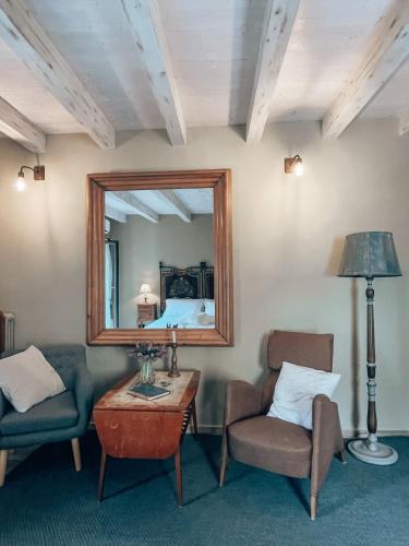 a living room with a couch and a mirror at Talking Stones in Dolceacqua