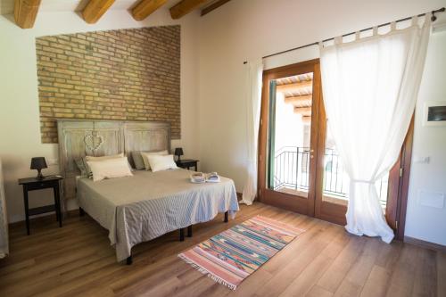 een slaapkamer met een bed en een groot raam bij Agriturismo Monte Scala in Taglio di Po