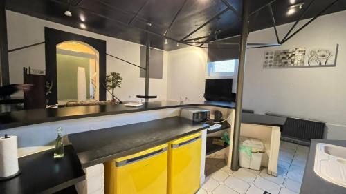 a kitchen with yellow cabinets and a sink at Haus Luise ideal Monteure in Delmenhorst