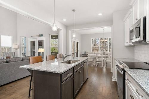 a kitchen and living room with a couch and a table at Beautiful Home with Lake and Marina Access, Firepit, Golf Cart Included in Estill Springs