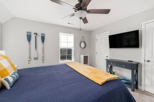 a bedroom with a bed and a ceiling fan at Beautiful Home with Lake and Marina Access, Firepit, Golf Cart Included in Estill Springs
