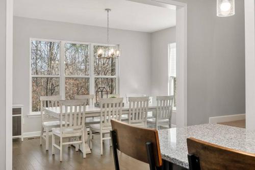 a dining room with a table and chairs and a window at Beautiful Home with Lake and Marina Access, Firepit, Golf Cart Included in Estill Springs
