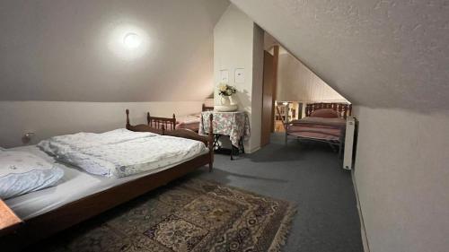 a small bedroom with two beds and a table at Haus Luise Monteure in Delmenhorst
