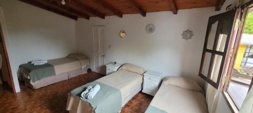 a bedroom with two beds and a window at Casa de Campo- Terra Viva in San Salvador de Jujuy