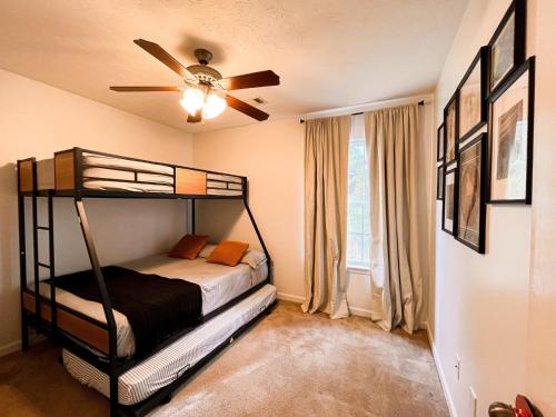 a bedroom with a bunk bed and a ceiling fan at Lovely House II in Auburn