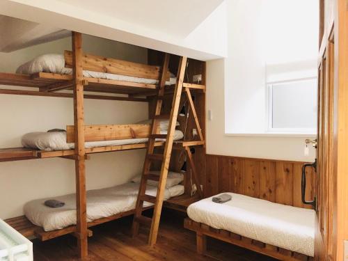 a bunk bed room with four bunk beds in it at Afan Forest BunkHouse-Fantastic 6 Rooms -Sleeps 23 in Glyncorrwg