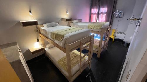 a room with two bunk beds and a window at Hostel Boutique Merced 88 in Santiago