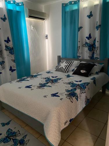a bedroom with a bed with blue curtains at AJ resort in Fontein