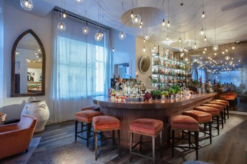 a bar in a room with a bunch of stools at International House Hotel in New Orleans