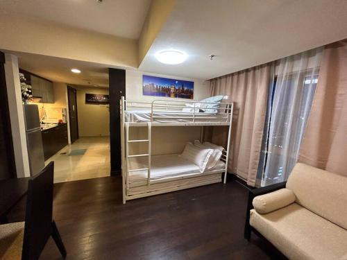 a room with a bunk bed and a living room at SunwayLagoonFamilySuite-4-7pax-Netflix-Balcony-Super Fast Internet in Kampong Penaga