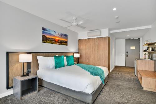 a bedroom with a large bed and a television at The Remington Orange in Orange