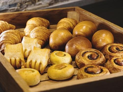 a wooden box filled with lots of different types of pastries at R&B HOTEL UENO HIROKOJI - Vacation STAY 13887v in Tokyo