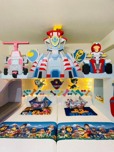 a bedroom with a superhero themed bed with a book at 芹菜芋頭親子民宿 in Taitung City