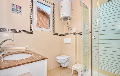 a bathroom with a toilet and a sink and a shower at 2 Bedroom Amazing Home In Wicie in Wicie