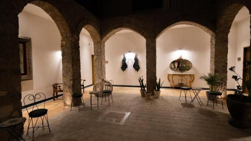 a large room with chairs and tables in a building at Villa Toscana ValQuirico Lofts & Suites Hotel Boutique in Santeagueda