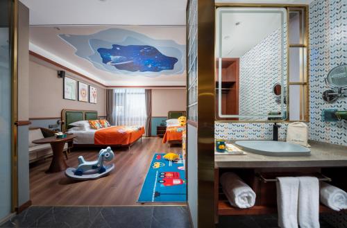 a hotel room with a bathroom and a bedroom at Nostalgia S Hotel - Beijing Xidan Financial Street in Beijing