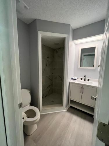 a bathroom with a toilet and a sink and a shower at Cypress Cove Waterfront Townhome with Boat Ramp in Inverness