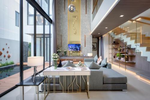 a living room with a couch and a table at Mida Grande Resort Phuket Official Account in Surin Beach