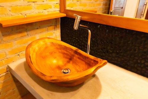 a wooden sink sitting on a counter in a bathroom at Vila Marina in Arraial d'Ajuda