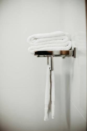 a pile of white towels sitting on a table at Colonial Motel Richmond in Richmond