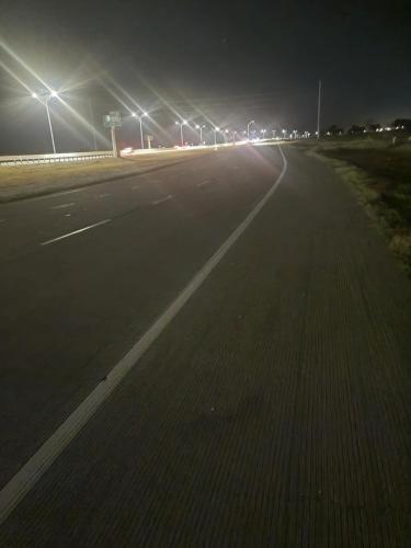 an empty highway at night with street lights at Hethos in Austin