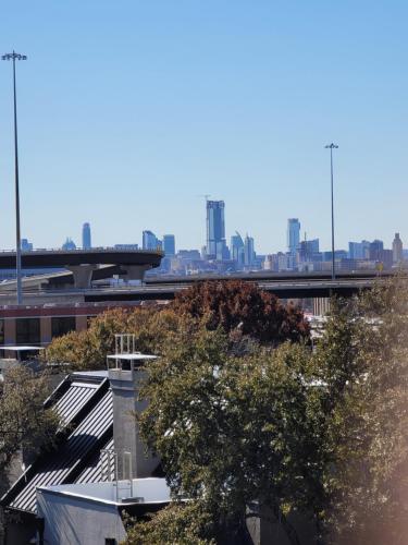 a view of a city skyline with a bridge and trees at Hethos in Austin