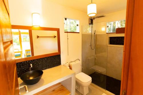 a bathroom with a sink and a toilet and a shower at Vila Marina in Arraial d'Ajuda