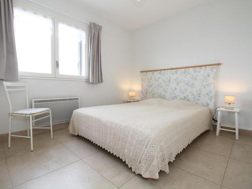 a bedroom with a bed and two tables and two windows at Appartement T3 à Balaruc-les-Bains avec WiFi et vue sur l'étang de Thau - FR-1-553-188 in Balaruc-les-Bains