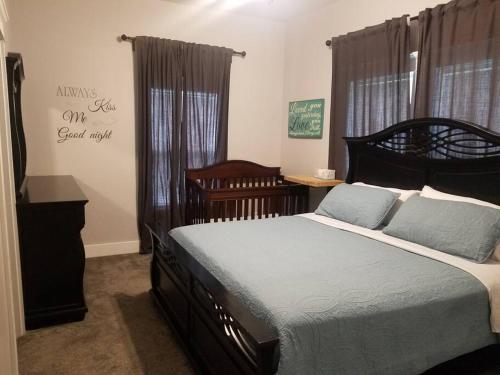 a bedroom with a large bed with blue pillows at The Sanctuary 14 acres w/pond/fishing/trails/etc. in Nashville