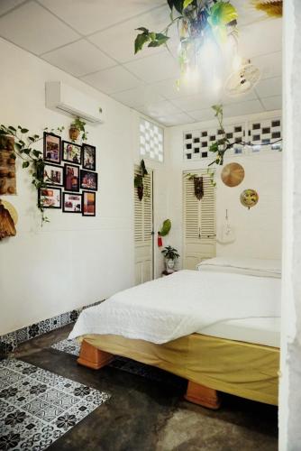 a bedroom with a bed in a room with plants at Mekong Pottery Homestay, Green-Friendly & Boat Tour in Vĩnh Long