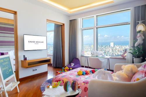 a childrens room with a bed and a tv at Grand Mercure Danang in Da Nang