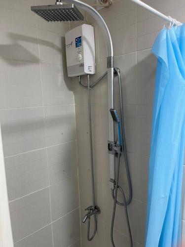 a shower in a bathroom with a shower head at Netflix- Destina Stays at Jazz Residences Makati, MetroManila in Manila