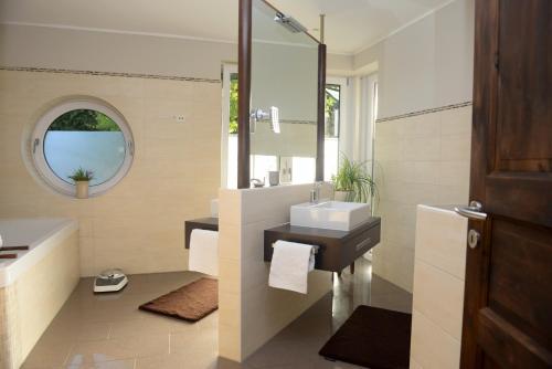 a bathroom with a sink and a mirror at Ferienwohnung Sofia in Papenburg