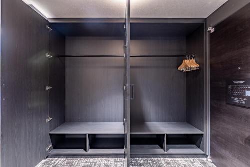 a walk in shower with glass doors in a room at Wyndham Garden Sapporo Odori in Sapporo