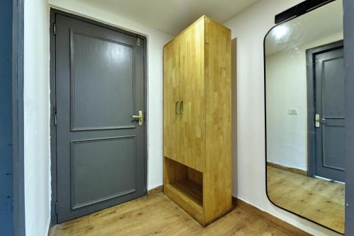 a hallway with a door and a mirror at Divine Inn Couple Friendly Hotel near Sector 51 Metro Station in Noida