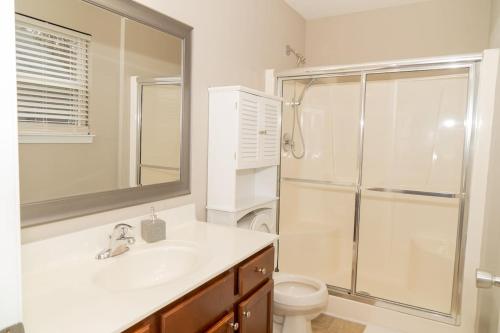 a bathroom with a sink and a shower and a toilet at Beautiful spacious 4 bedroom house , sleeps 8+ in Raleigh