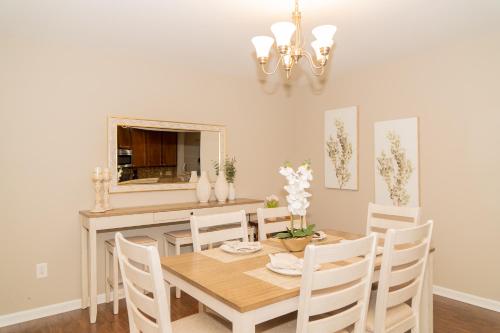 a dining room with a table and chairs and a mirror at Beautiful spacious 4 bedroom house , sleeps 8+ in Raleigh