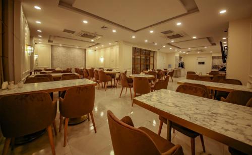 a restaurant with tables and chairs and a room with tables at ALKAN PALACE HOTEL in Keşan