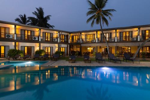 a hotel with a swimming pool in front of a building at Kithala Resort - Thema Collection in Tissamaharama