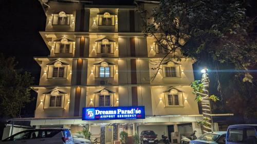 a large building with a sign in front of it at DREAMS PARADISE AIRPORT RESIDENCY in Nedumbassery